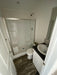 Interior of the bathroom in the Champion Home No Loft by Oasis Tiny Estates, equipped with modern fixtures and vinyl flooring.