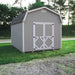  A beige barn positioned between two roads, showcasing the Value 6-foot model