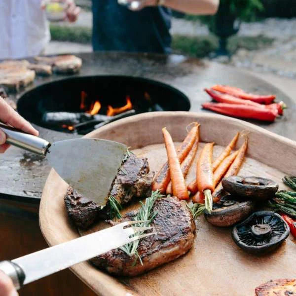 Succulent steaks, carrots, and mushrooms grilled to perfection on the Arteflame Black Label Euro 40" Grill's seamless cooktop.
