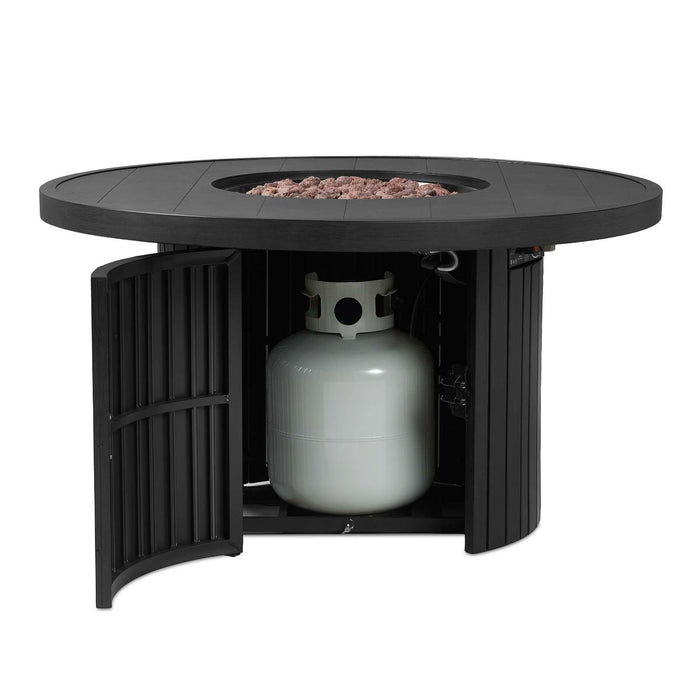 Real Flame Calvin fire pit table with base doors open revealing hidden interior propane tank storage compartment, lava rocks visible in the burner bowl above