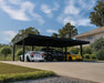 Large black and grey Canopia Oslo carport installed on a residential driveway covering multiple vehicles