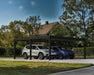Black and grey Canopia Oslo carport covering two vehicles in a residential outdoor driveway