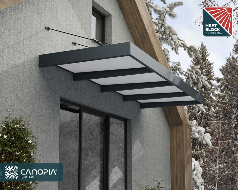 Canopia XL 4000 Awning mounted on a building, featuring advanced heat block technology.