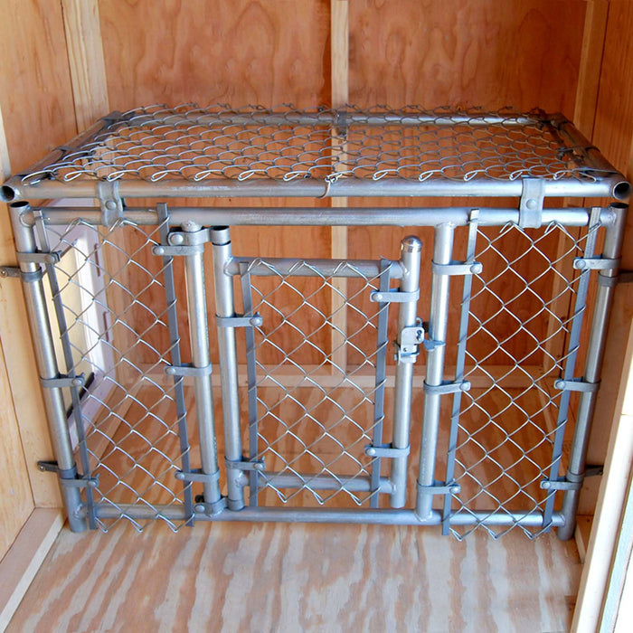 Interior of Cape Cod Cozy Kennel showing secure metal fencing and wooden walls inside the kennel structure.