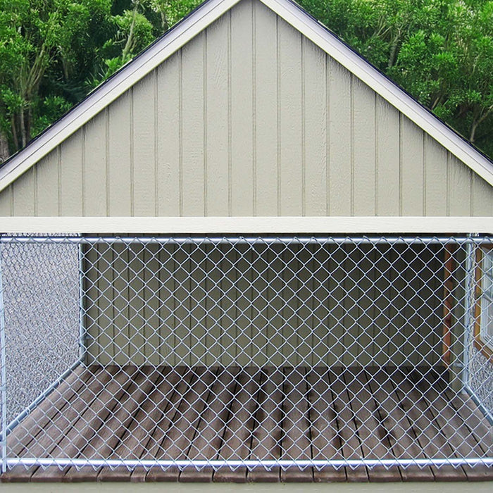 Side view of Little Cottage Co. Cape Cod Cozy Kennel showcasing the chain-link fenced outdoor dog run attached to the shed.