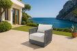 Elementi Capri Collection lounge chair elegantly placed on a luxurious patio with breathtaking ocean views, showcasing gray and white color contrast.