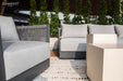 Detailed close-up of the Capri Collection outdoor sofa and chair by Elementi highlighting plush gray cushions, premium fabric, and contemporary design.