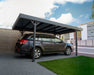 Side view of a car parked under the Canopia Palma 5000 Carport in gray.