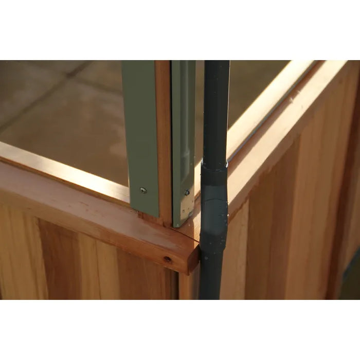 Cedar frame with a drainage fitting detail inside the Alton Lancing Greenhouse.