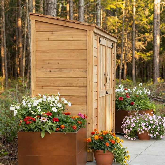 Side angle view of the cedar-sided Grand Garden Chalet 6x3 shed showing its peaked roof and wood-paneled walls.