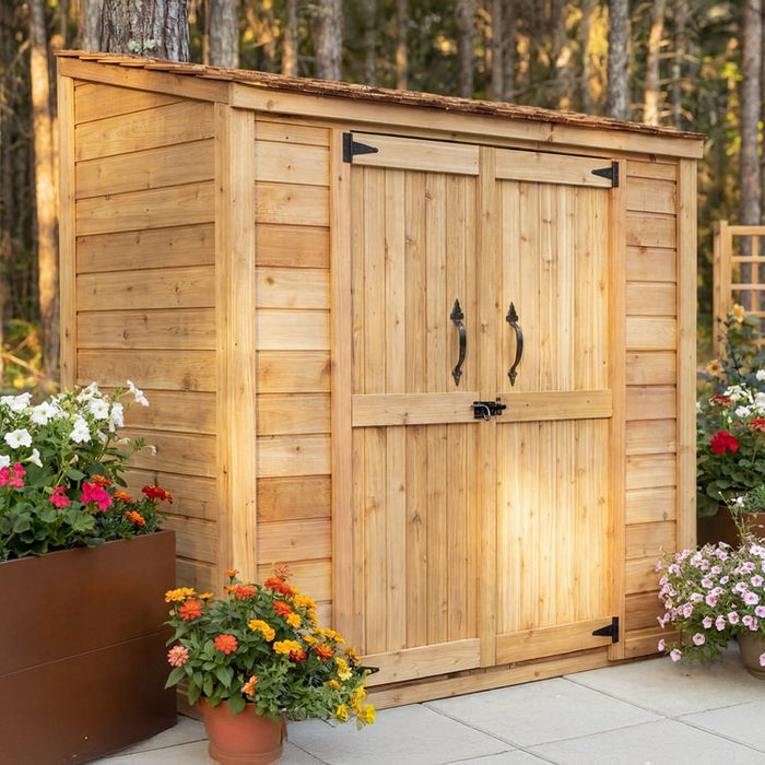 Side angle view of the cedar Grand Garden Chalet shed showing its wood siding and peaked roof design.