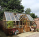 Cambridge Greenhouse by Alton Cedar Structure with natural light streaming through the glass panels.