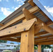 Close-up of cedar beam and metal roof detail on an Outdoor Living Today grill gazebo designed for BBQ protection