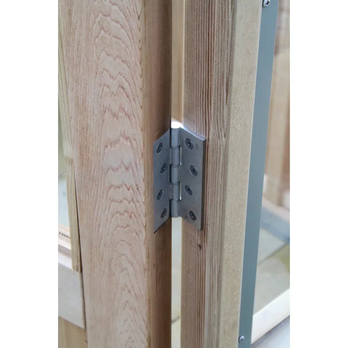 A robust metal hinge fitted to the cedar-framed door of the Alton Lancing Greenhouse.