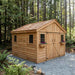 Cedar storage shed measuring 12x12 with double doors, shown from a side angle in an outdoor setting.