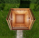 Close-up detail of the 6x6 cedar Maximizer storage shed, showing wood grain, door hardware, and joinery.