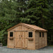 Front view of the cedar Space Master 12x16 storage shed with double doors closed, set against a plain background.