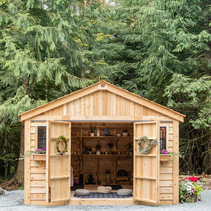 Side angle view of the 12x16 cedar Space Master storage shed showing its double door entrance and wood siding.