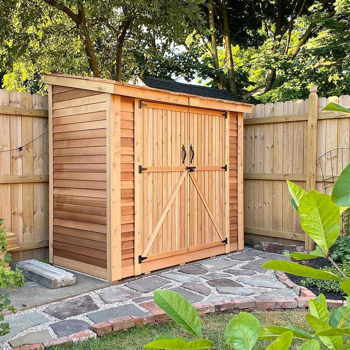 Side view of the 8x4 cedar SpaceSaver storage shed showing its double door entrance and sloped roof design.