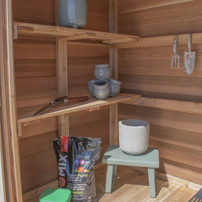 Closeup of the cedar storage shed's double door detail on the SpaceMaster 6x4, showing wood grain and hardware.