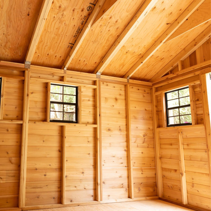 Close-up of the cedar storage shed's double door detail, showing natural wood grain and sturdy hardware.