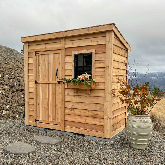 Side angle view of the cedar SpaceSaver 8x4 storage shed showcasing its single door and compact wood construction.