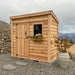 Side angle view of the cedar SpaceSaver 8x4 storage shed showcasing its single door and compact wood construction.
