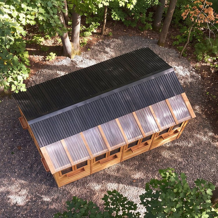 Cedar Sunshed garden shed 12x16 shown in close-up, highlighting wood grain texture and construction detail.