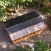 Cedar Sunshed garden shed 12x16 shown in close-up, highlighting wood grain texture and construction detail.