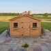 Detail view of the cedar Sunshed Garden Shed 12x16, showcasing its wood paneling and sturdy roof construction.
