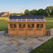 Cedar Sunshed garden shed 12x16 detail view showing wood siding texture and window trim construction.