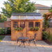 Close-up detail of the cedar Sunshed 8x8 garden shed, showing wood grain and craftsmanship of the paneling.