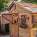 Detail view of the cedar Sunshed 8x8 garden shed, showcasing its wood grain, door hardware, and window trim.