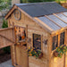 Detail view of the cedar Sunshed 8x8 garden shed, highlighting its wood construction and window design.