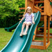 A child playing on the slide of the playset