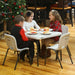 Lifetime 13 Pack Children's Stack Chair used at kids table with holiday meal setting near decorated Christmas tree