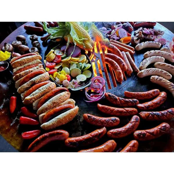 Grilled feast on Arteflame Classic 40" Black Label Grill, vibrant vegetables and sausages highlighting the grill's versatility.