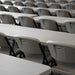 Rows of Lifetime 4-Pack Classic Folding Chairs in putty arranged with rectangular tables for training or classroom use