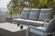 Close-up view of a modern patio seating arrangement with the Elementi Tevere Series Rectangle Coffee Table in Space Grey and matching cushions.