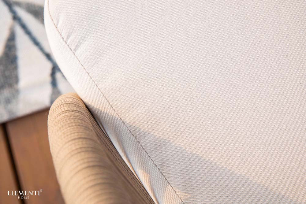 Detailed close-up of cream-colored cushion fabric from Elementi’s Malibu Collection, showcasing premium outdoor materials and stitching craftsmanship.