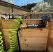 Connection setup of the Outdoor Living Today (OLT) Auto-Watering Kit with a coiled hose ready for garden use.