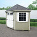 Front view of the Little Cottage Co. Colonial Five-Corner Shed with white double doors and a window with shutters.
