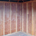 Interior view of the Little Cottage Co. Colonial Five-Corner Shed showing unfinished wooden walls and framing.