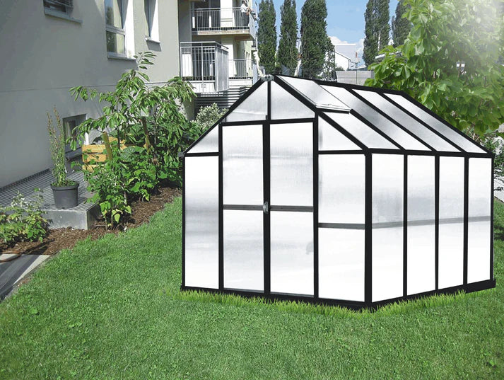 Compact 8 ft Growers Supply greenhouse with sturdy black frame and clear panels placed on lawn near residential home