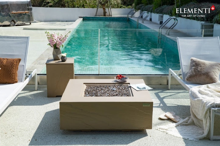 Elementi Plus Concrete Fire Pit Table OFG411SY beside a pool