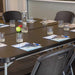 Lifetime 6-Foot Folding Table in black set up for meeting with chairs, glasses, and notepads