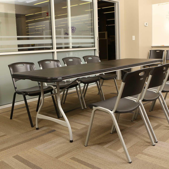 Lifetime 4 Pack 8-Foot Black Nesting Table arranged with chairs in meeting room setup for extra seating