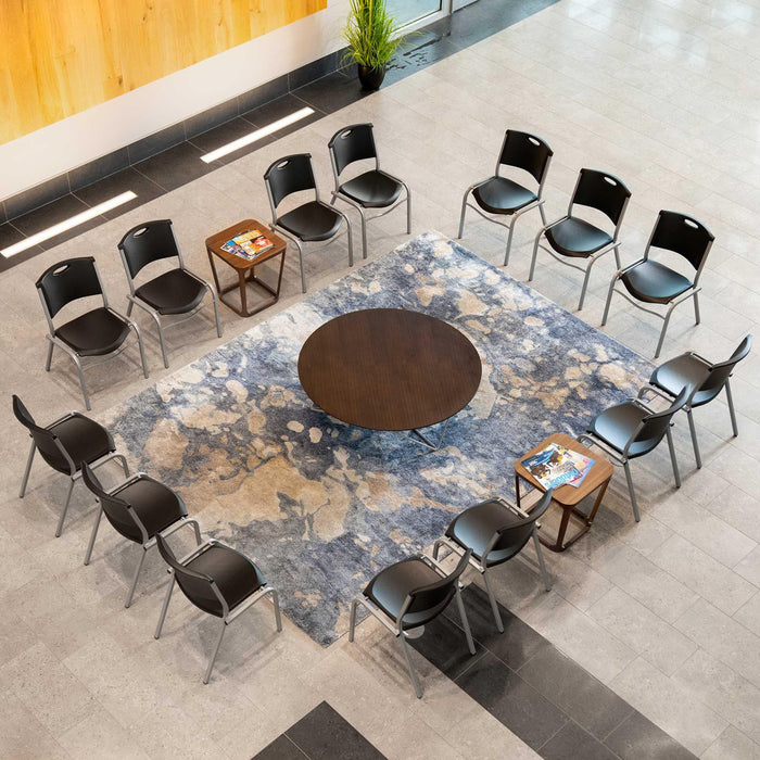 Overhead view of Lifetime 14 Pack Stacking Chair placed around rug and tables in meeting area