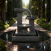 Contemporary Exaco Trio Bowl water fountain with three elevated bowls and tranquil water flow placed in an elegant courtyard garden setting