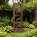 Contemporary rustic cascade water feature with stacked spillways, surrounded by vibrant garden plants and manicured lawn